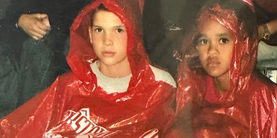 Left to right: Reece Elliot and Derrick White as kids. Both are wearing read rain ponchos.