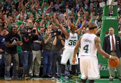 (042416 Boston,MA) Boston Celtics guard Marcus Smart celebrates with the crowd including New England Patriots LeGarrette Blount (L) after the win. Boston Celtics face the Atlanta Hawks in game 4 of round 1 of the NBA playoffs at the TD Garden on Sund