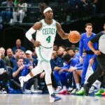 Jan 22, 2024; Dallas, Texas, USA; Boston Celtics guard Jrue Holiday (4) brings the ball up the court during the first quarter against the Dallas Mavericks at American Airlines Center. Mandatory Credit: Andrew Dieb-USA TODAY Sports