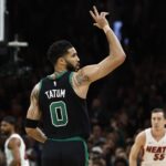 Boston Celtics forward Jayson Tatum (0) celebrates a three point basket against the Miami Heat during the first quarter of game five of the first round of the 2024 NBA playoffs at TD Garden.