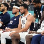 United States small forward Jayson Tatum (10), guard Devin Booker (15), shooting guard Stephen Curry (4) and guard Anthony Edwards (5) look on from the bench during the first half against Serbia in a men's basketball semifinal game during the Paris 2024 Olympic Summer Games at Accor Arena.