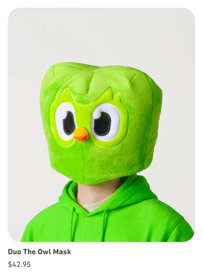 Duo the Owl Mask, a plush, overhead furry mask, is displayed by a model and priced at $42.95.
