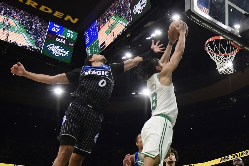 Boston Celtics forward Josh Minott (8) dunks the ball while Orlando Magic guard Anthony Black (0) defends during the second half at TD Garden.