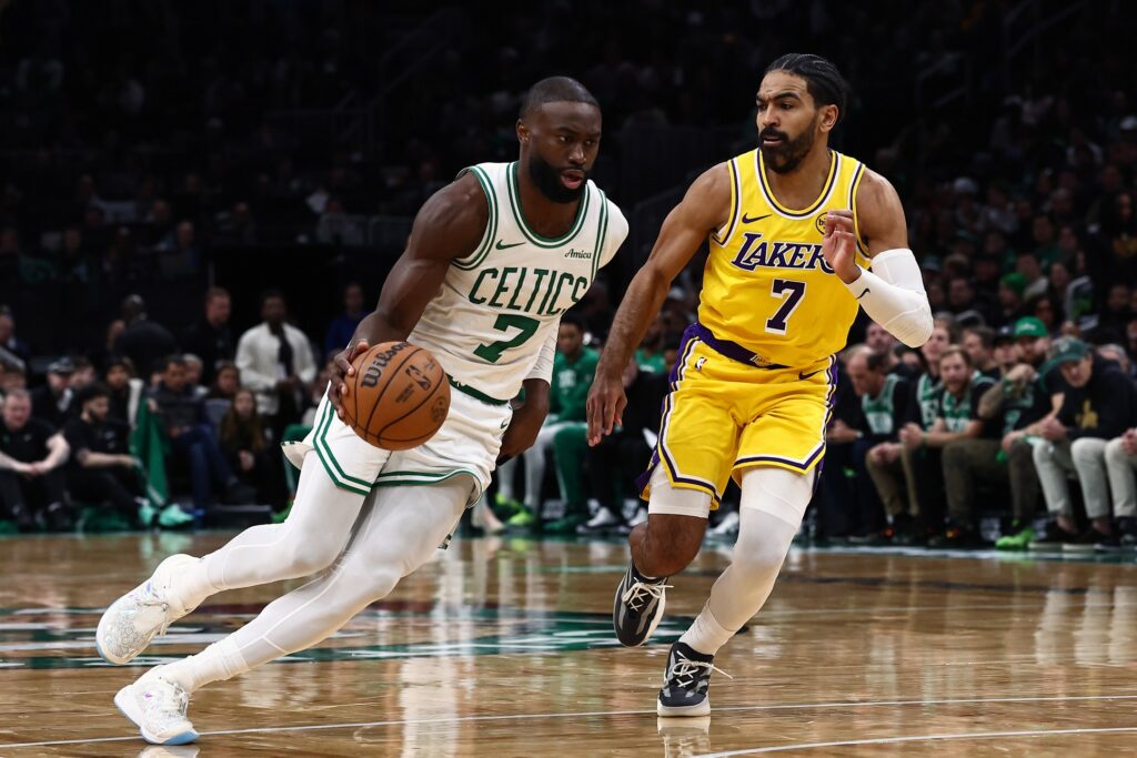 Dec 5, 2025; Boston, Massachusetts, USA; Boston Celtics guard Jaylen Brown (7) drives past Los Angeles Lakers guard Gabe Vincent (7) during the second half at TD Garden. Mandatory Credit: Winslow Townson-Imagn Images