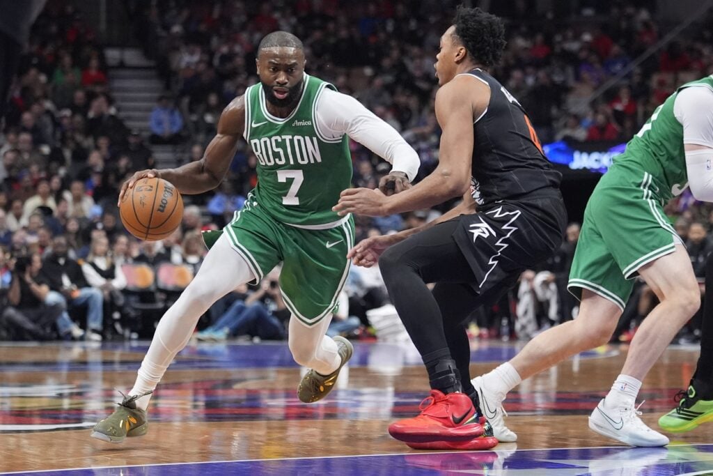  Boston Celtics forward Jaylen Brown (7) tries to dribble around Toronto Raptors guard Scottie Barnes (4) during the first half at Scotiabank Arena.