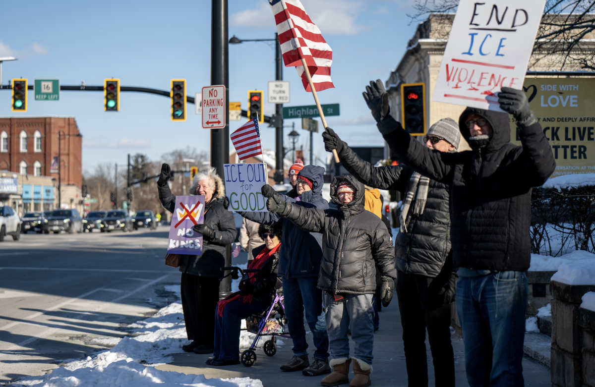 A large crowd of protesters endured 22-degree weather outside of the First Unitarian Universalist Society in Newton (FUUSN) to rally against the policies of President Donald Trump’s second administration on the anniversary of his inauguration on Tuesday.