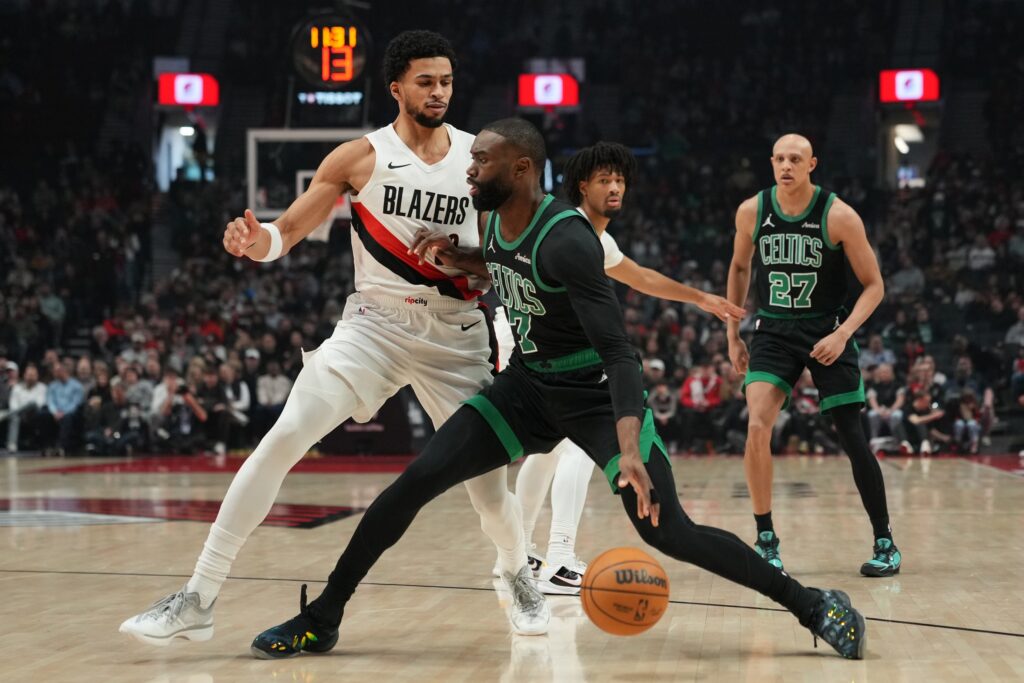 Boston Celtics guard Jaylen Brown (7) handles the ball against Portland Trail Blazers forward Toumani Camara (33) during the first half at Moda Center.