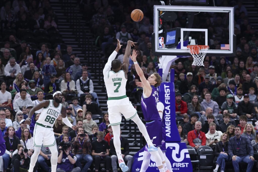 Dec 30, 2025; Salt Lake City, Utah, USA; Boston Celtics guard Jaylen Brown (7) shoots over Utah Jazz forward Lauri Markkanen (23) during the second half at Delta Center. Mandatory Credit: Rob Gray-Imagn Images